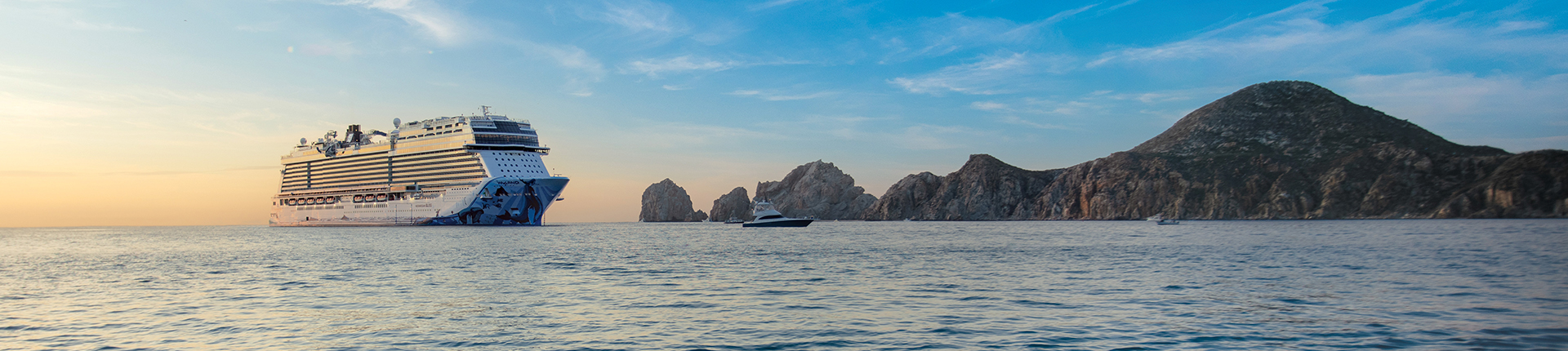 Norwegian Bliss cruise ship at sea in Cabo San Lucas, Mexico during sunset